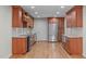 Spacious kitchen featuring stainless steel appliances, granite countertops, and rich wood cabinetry at 1005 Greenwood Cir, Cary, NC 27511
