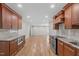 Open kitchen featuring stainless appliances, granite countertops, and a seamless transition to living spaces at 1005 Greenwood Cir, Cary, NC 27511
