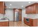 Well-equipped kitchen with stainless steel refrigerator, granite countertops, and generous storage at 1005 Greenwood Cir, Cary, NC 27511