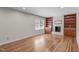 Bright living room with hardwood floors, built-in shelving, and a brick fireplace at 1005 Greenwood Cir, Cary, NC 27511