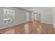 Bright living room featuring hardwood floors and large windows providing natural light at 1005 Greenwood Cir, Cary, NC 27511
