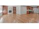 Open living space with hardwood floors, built-in bookshelves, and a view of the updated kitchen at 1005 Greenwood Cir, Cary, NC 27511