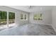Bright sunroom with tile flooring, ceiling fan, and sliding glass doors to the deck at 1005 Greenwood Cir, Cary, NC 27511