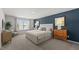 Comfortable main bedroom featuring a stylish blue accent wall and plush neutral-toned carpet at 1017 Middlecrest Dr, Rocky Mount, NC 27804
