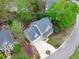 Aerial view of home with a manicured yard, driveway, and covered front porch at 102 Parkbranch Ln, Cary, NC 27519