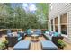 Outdoor deck with ample seating, fire pit, outdoor grill and mature trees at 102 Parkbranch Ln, Cary, NC 27519