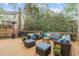 Outdoor deck with ample seating, fire pit, outdoor grill and mature trees at 102 Parkbranch Ln, Cary, NC 27519