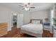 Cozy bedroom with hardwood floors, ceiling fan, and neutral decor at 102 Parkbranch Ln, Cary, NC 27519