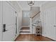 Bright foyer featuring hardwood floors, stairs, and a decorative table at 102 Parkbranch Ln, Cary, NC 27519