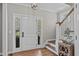 Welcoming foyer with hardwood floors, stairs, and a charming entryway display at 102 Parkbranch Ln, Cary, NC 27519