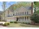 Charming two-story home featuring a covered front porch, well-manicured landscaping, and a two-car garage at 102 Parkbranch Ln, Cary, NC 27519