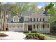 Charming two-story home featuring a covered front porch, well-manicured landscaping, and a two-car garage at 102 Parkbranch Ln, Cary, NC 27519