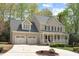 Charming two-story home featuring a covered front porch, well-manicured landscaping, and a two-car garage at 102 Parkbranch Ln, Cary, NC 27519