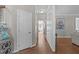 Hallway featuring hardwood floors leading to a living area and multiple rooms at 102 Parkbranch Ln, Cary, NC 27519