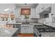 The kitchen features an island with granite countertops and a view of the living area at 102 Parkbranch Ln, Cary, NC 27519
