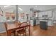Open floor plan featuring a kitchen with granite countertops that flows into the dining room and sunroom at 102 Parkbranch Ln, Cary, NC 27519
