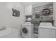 Well-organized laundry room with washer, dryer, sink, and stylish wood accent wall at 102 Parkbranch Ln, Cary, NC 27519