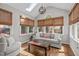 The sunroom features a vaulted ceiling, ample lighting, and wood flooring at 102 Parkbranch Ln, Cary, NC 27519