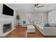 Spacious living room featuring a fireplace, hardwood floors, and a large sectional sofa at 102 Parkbranch Ln, Cary, NC 27519
