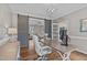 Open office space with barn doors, stylish lighting, and views into the living area at 102 Parkbranch Ln, Cary, NC 27519