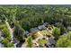 A picturesque aerial view of a peaceful neighborhood nestled amongst mature trees at 103 Caymus Ct, Cary, NC 27519