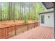 A wooden back deck overlooks a beautiful wooded area, perfect for outdoor gatherings at 103 Caymus Ct, Cary, NC 27519
