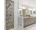 Modern bathroom featuring a beautiful walk-in shower with custom tile work and double vanity at 103 Caymus Ct, Cary, NC 27519