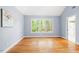 Serene bedroom featuring hardwood floors, ample natural light, and a neutral color palette at 103 Caymus Ct, Cary, NC 27519