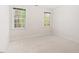 Bedroom featuring neutral carpet, two windows with natural light, and light walls at 103 Caymus Ct, Cary, NC 27519