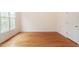 Well-lit bedroom with hardwood floors, neutral walls, and ample space at 103 Caymus Ct, Cary, NC 27519
