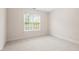 Cozy bedroom with neutral carpet, white walls, and a double window providing natural light at 103 Caymus Ct, Cary, NC 27519