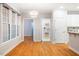 Bright dining area featuring hardwood floors, large windows, and modern lighting, perfect for gatherings at 103 Caymus Ct, Cary, NC 27519