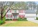 Charming two-story home with red shutters, landscaped lawn, and brick front steps at 103 Caymus Ct, Cary, NC 27519