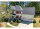 Beautiful two-story home featuring a well-manicured front yard and attached two-car garage at 103 Caymus Ct, Cary, NC 27519