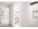 Hallway with view of bathroom, featuring neutral walls and a glimpse of the bathroom's vanity and mirror at 103 Caymus Ct, Cary, NC 27519