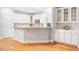 Bright kitchen with modern white cabinets, stainless steel appliances, and hardwood floors at 103 Caymus Ct, Cary, NC 27519