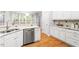 Bright, stylish kitchen featuring stainless steel appliances, granite counters, and white cabinetry at 103 Caymus Ct, Cary, NC 27519