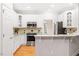 Well-appointed kitchen with stainless steel appliances, white cabinetry, and granite countertops at 103 Caymus Ct, Cary, NC 27519