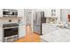 Modern kitchen featuring stainless steel appliances, white cabinets, and granite countertops at 103 Caymus Ct, Cary, NC 27519
