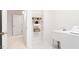 Bright laundry room featuring a utility sink and shelving for storage solutions at 103 Caymus Ct, Cary, NC 27519