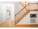 Inviting foyer showcasing hardwood floors, a wooden staircase, and ample natural light filtering through the doorway at 103 Caymus Ct, Cary, NC 27519