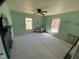 Spacious bedroom with a ceiling fan, cozy carpet, and ample natural light, making for a serene retreat at 104 N 16Th St, Erwin, NC 28339