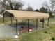 Carport with gravel base, offering covered parking, and surrounded by green space at 104 N 16Th St, Erwin, NC 28339