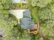 Aerial view of a home with a driveway, deck, and well-maintained landscaping at 105 Toynbee Pl, Chapel Hill, NC 27514