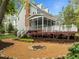 View of backyard of an elegant two-story home with landscaped garden and fire pit at 105 Toynbee Pl, Chapel Hill, NC 27514