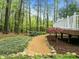 A backyard features a meandering stone-lined path through lush landscaping at 105 Toynbee Pl, Chapel Hill, NC 27514
