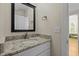 Bathroom featuring granite countertops and a framed vanity mirror at 105 Toynbee Pl, Chapel Hill, NC 27514