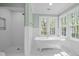 Lovely bathroom features a soaking tub, glass-enclosed shower, and natural light at 105 Toynbee Pl, Chapel Hill, NC 27514
