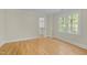 A light and airy bedroom featuring hardwood floors, a walk-in closet, and large windows at 105 Toynbee Pl, Chapel Hill, NC 27514