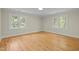 Bright, open bedroom with hardwood floors and large windows at 105 Toynbee Pl, Chapel Hill, NC 27514